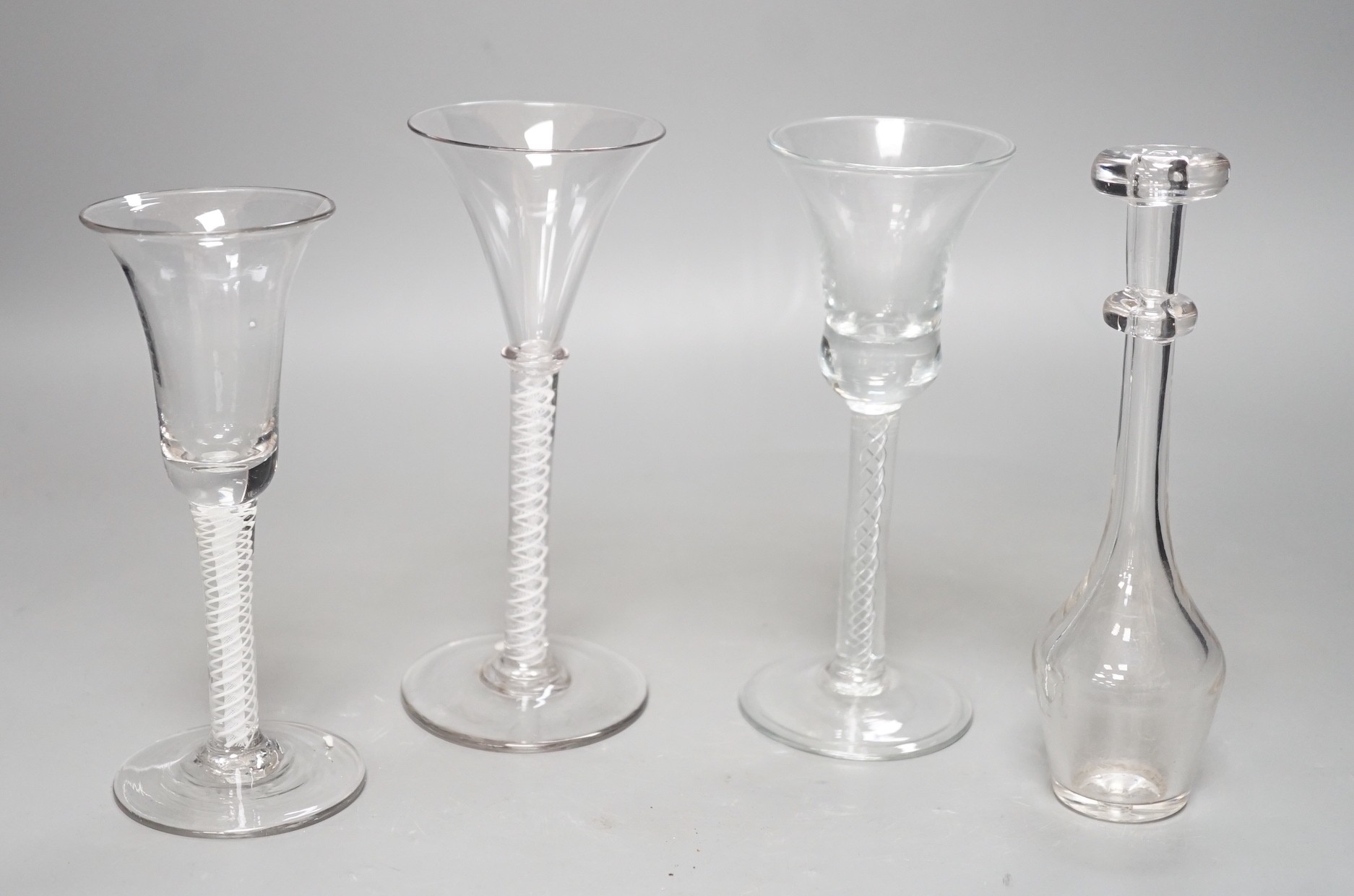 Three opaque or airtwist stem drinking glasses together with a Toddy lifter - 18cm high